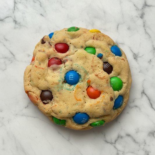 Cookies with colorful M&M candies on a marble background 